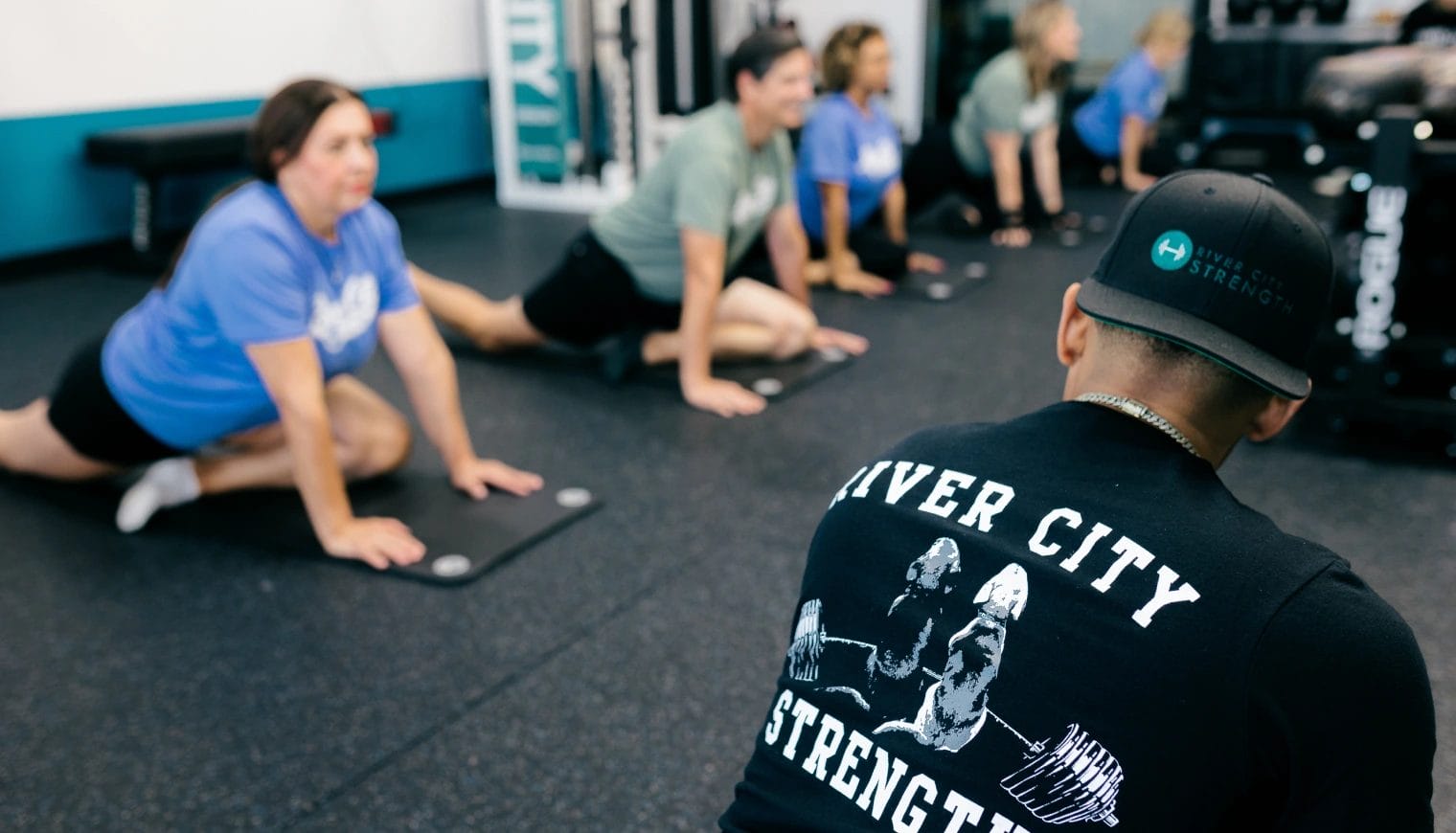 man in black shirt with 5 womans do exercices