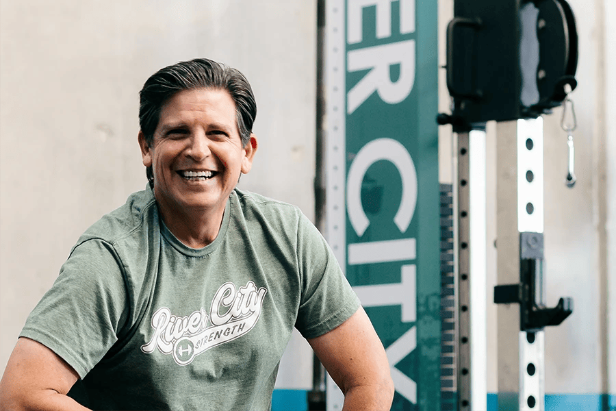 man smiling while working out at River City Strength